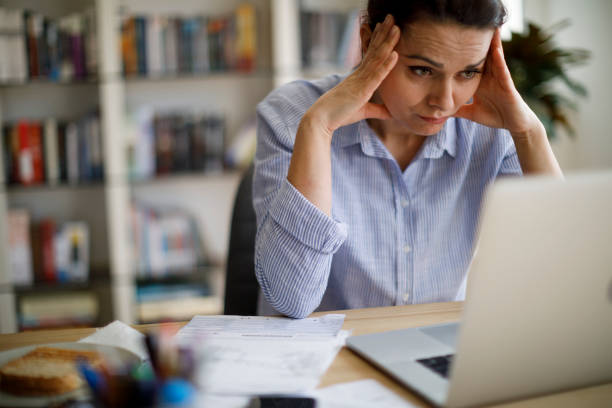 istock Worried woman looking at computer screen 1203592475