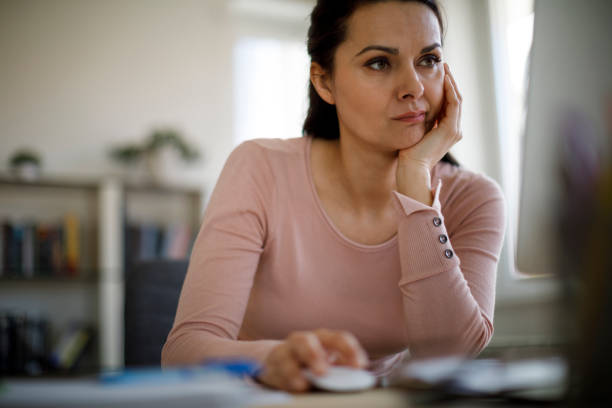 istock Worried businesswoman looking at computer screen 1203592522