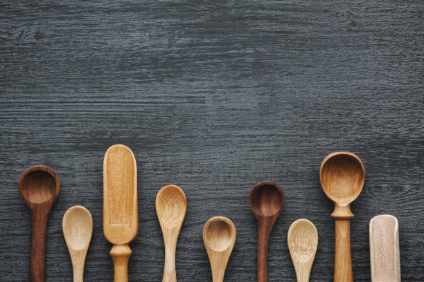 istock Empty wooden spoons and scoops on gray wooden kitchen table. Top view. 1203593845