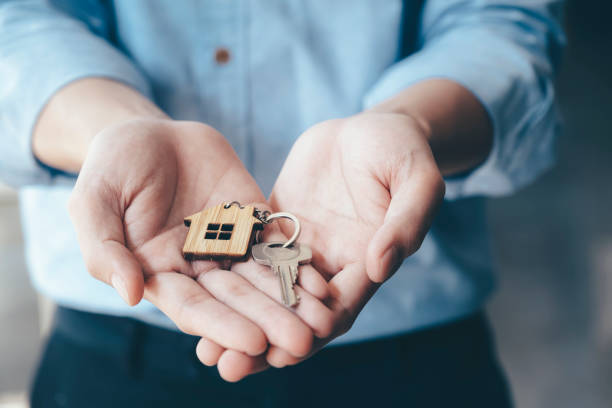 istock Giving, offering, demonstration, holding house keys. 1203594164