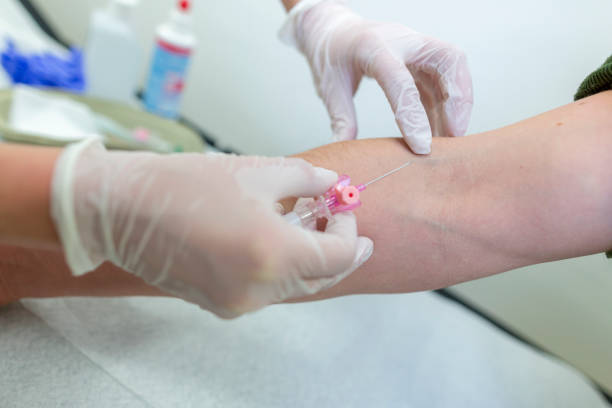 istock Doctor injects an infusion needle into a patient 1203594366