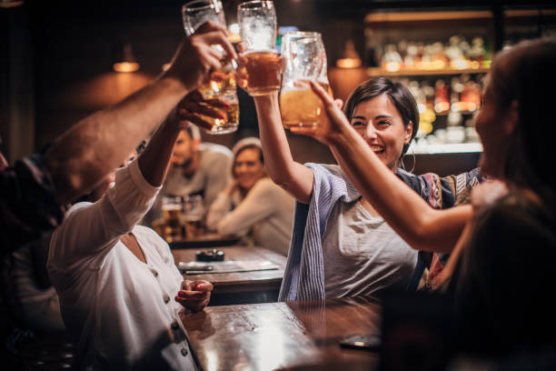 istock Happy friends in pub 1203594973