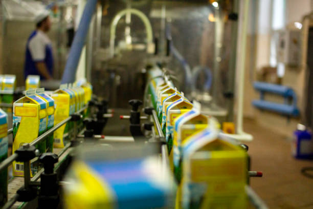 Dairy products on the factory milk packaging line. Dairy products in the package are moved on a conveyor belt . stock photo