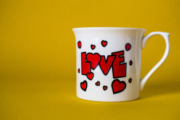 istock Valentines day love coffee cup on yellow background 1203595436