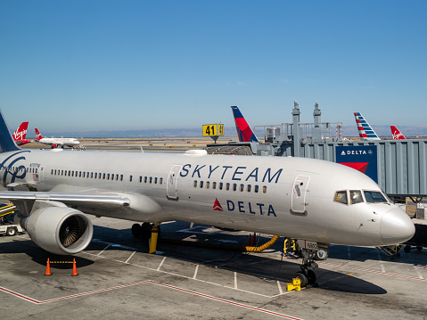 Denver, CO July 17, 2018: Delta skyteam plane on runway connected to terminal by a passenger boarding bridge