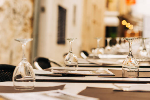 istock Empty set up restaurant terrace with tables and chairs 1203597972