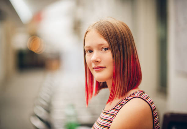 Outdoor close up portrait of pretty teenage girl with red dyed hair stock photo