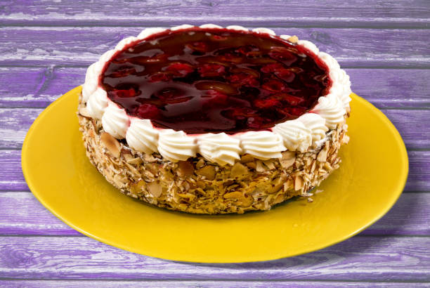 istock Cherry cake with white cream on yellow plate. 1203600451