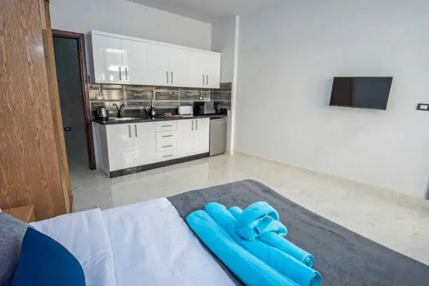 Photo of Interior design of bedroom in studio apartment with kitchen
