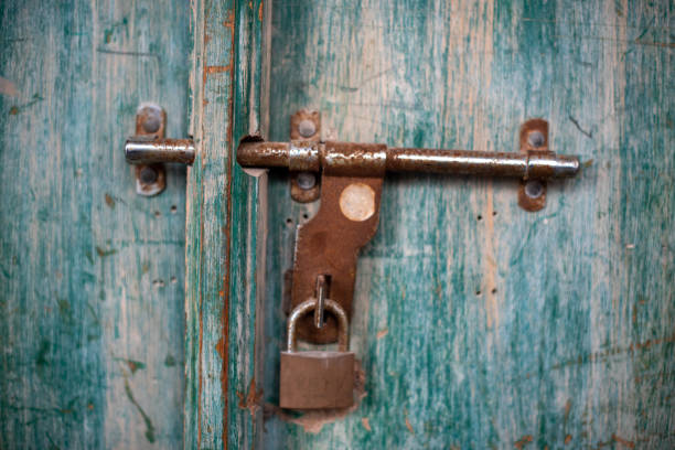 istock A retro iron padlock on a grunge door 1203601882