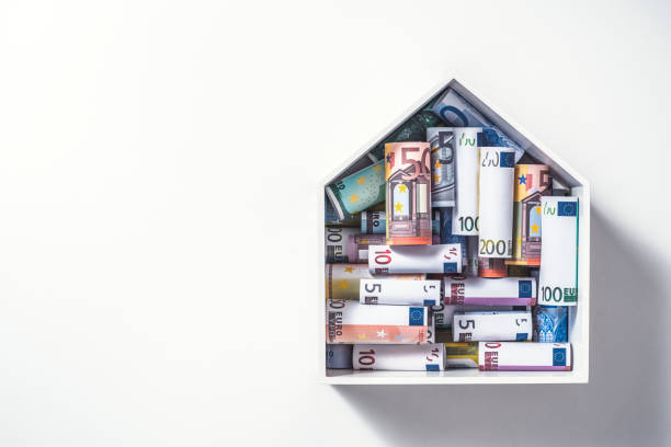 Money for a house, euro Euro rolls in house shape box, mortgage concept. Money for a house. money house stock pictures, royalty-free photos & images
