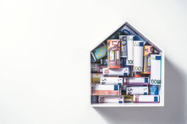 Money for a house, euro Euro rolls in house shape box, mortgage concept. Money for a house. wealthy house stock pictures, royalty-free photos & images