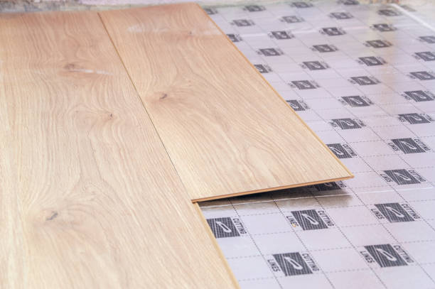 istock Laying laminate flooring - close-up on floor panel. 1203604200