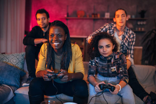 istock Young friends playing video games 1203604420
