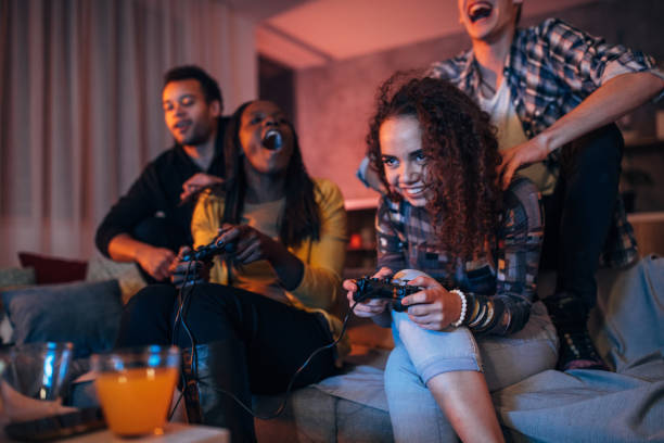 istock Young friends playing video games 1203604491