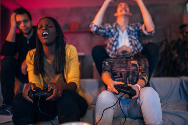 istock Young friends playing video games 1203604544