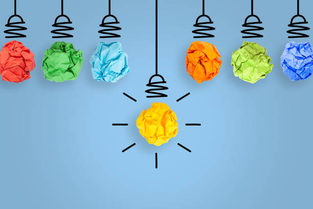 istock New Idea Concepts with Light Bulb Crumpled Paper on Blue Background 1203604687