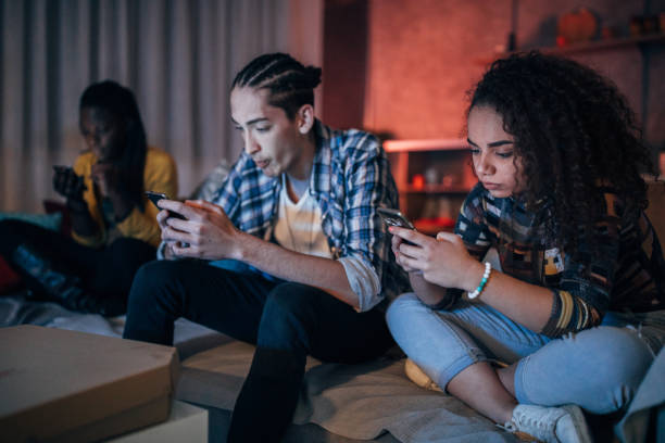 istock Multi-ethnic group of friends using phones 1203605225