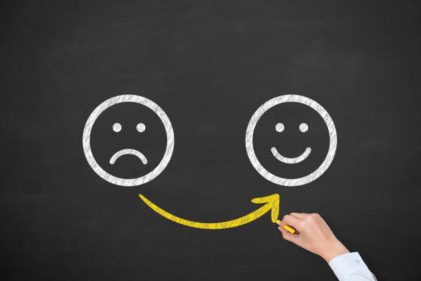istock Hand Drawing Unhappy and Happy on Blackboard 1203606965