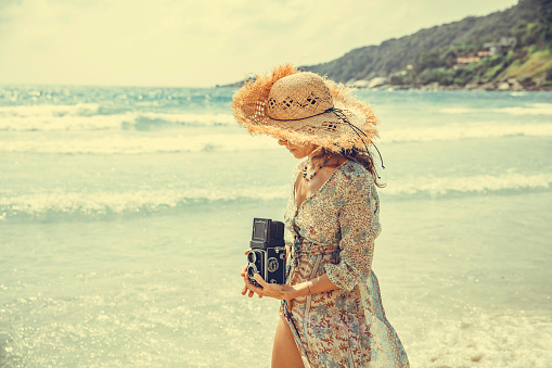 Woman taking photo on the tropical beach