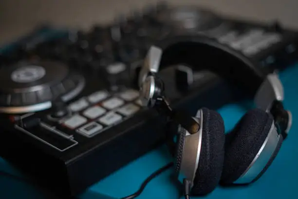 Photo of Headphone and sound audio controller. music mixer dj pult