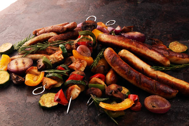 istock Assorted delicious grilled meat with vegetable on a barbecue with Grilled pork shish or kebab on skewers with vegetables. 1203608199