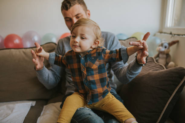 istock Happy father with his son playing at home on the bed 1203610755