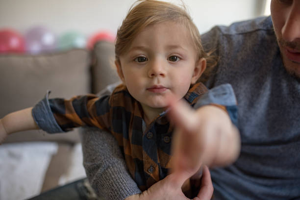 istock Happy father with his son playing at home on the bed 1203610885