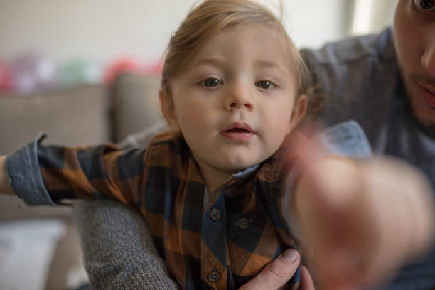 istock Happy father with his son playing at home on the bed 1203610917