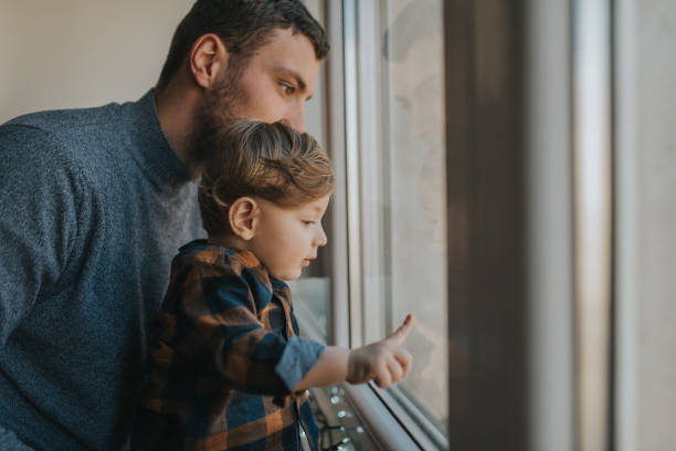 istock Happy father with his son playing at home behind the window 1203611192