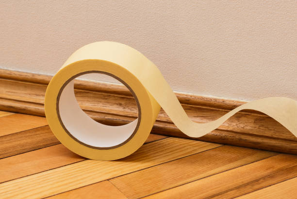 istock Masking tape to mask the skirting board 1203611239