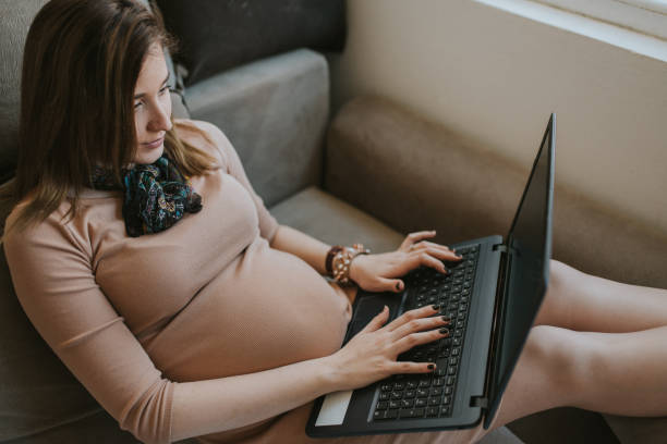 istock Pregnant woman using laptop 1203612017