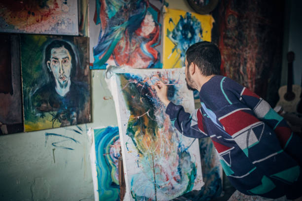 istock Artist- painter working on painting in studio 1203612183