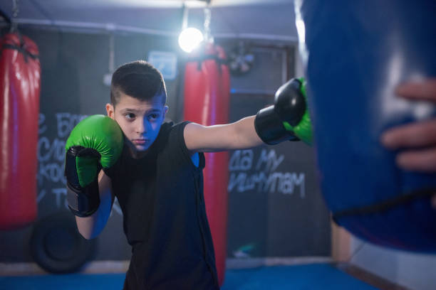 istock Young kickbox fighter exercises blows on the pear 1203612476