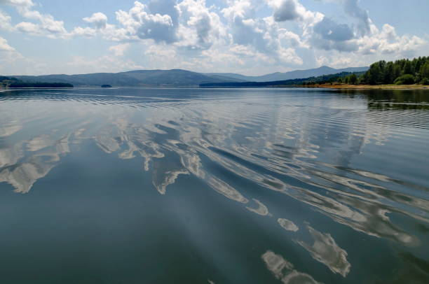 istock Natural reflection on Vlasina Mountain Lake and beautiful cloudy sky 1203612486