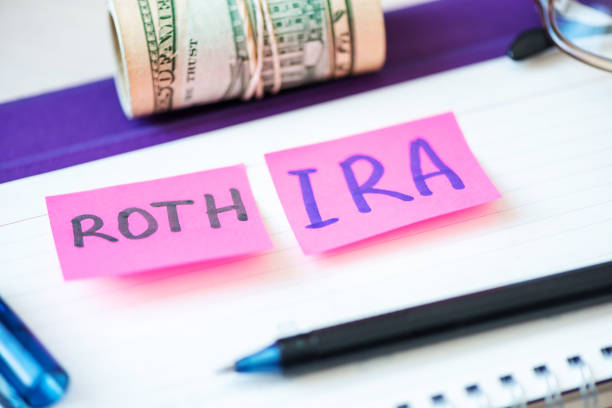 401k ira roth on pieces of colorful paper dollars on table. Pension concept. Retirement plans. Words 401k ira roth on pieces of colorful paper, money dollars and glasses on table. Pension concept. Retirement plans. gold ira rollover companies stock pictures, royalty-free photos & images