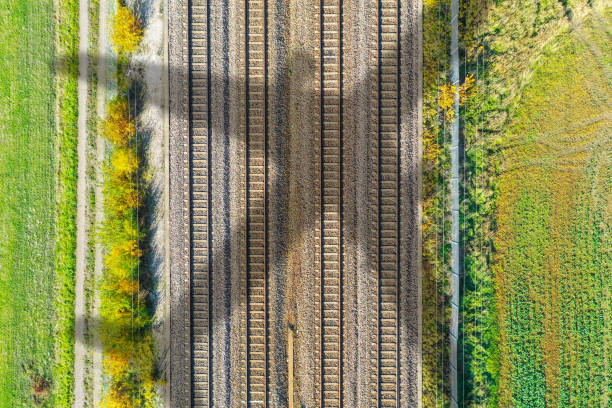 istock Airplane casting shadow on fall railroad in landscape 1203616129
