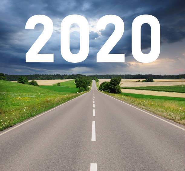 istock 2020 sign over country road , dramatic sky 1203616192