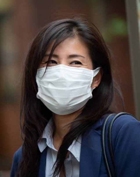 istock Asian woman wearing face mask 1203616231