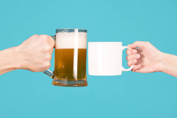 male hand and glass with beer against the girl's hand with a mug of tea or coffee a man s hand holds out a glass of beer, and in response, the girl s hand holds out a mug of tea or coffee sobriety stock pictures, royalty-free photos & images