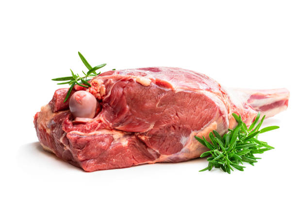 istock Fresh raw lamb leg with rosemary leaves isolated on white 1203619081