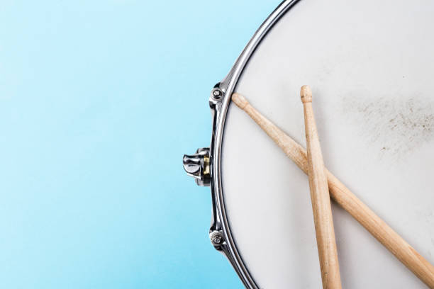 Drumming equipment with copy space Fragment of a Snare drum and drumsticks on light blue background with copy space for text. Music festival and study and school advertising concept bass instrument photos stock pictures, royalty-free photos & images