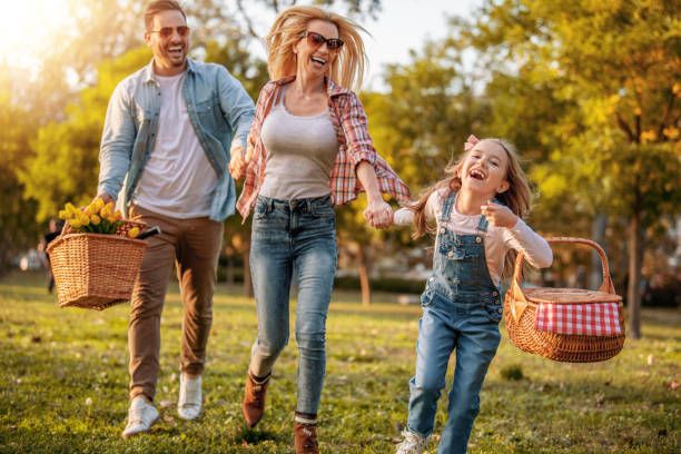 istock Happy family in summer park 1203620856