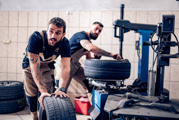 istock Mechanics working on car tires in his shop 1203622256