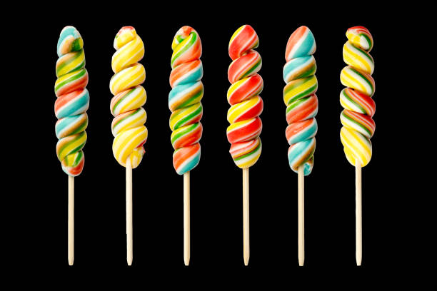 conjunto de longos pirulitos em pau de madeira. isolado em fundo preto. caramelo arco-íris - flavored ice lollipop candy affectionate - fotografias e filmes do acervo