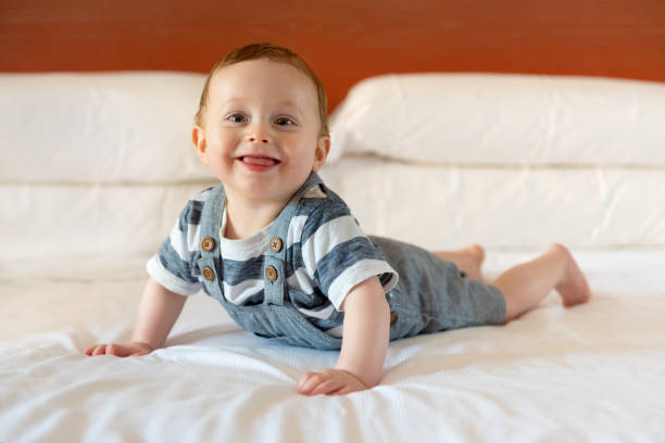 istock Baby boy 8 months old smiling on bed 1203622643