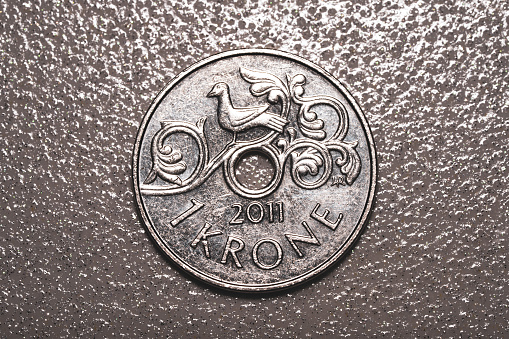 Norwegian metal coin with denomination of one Norwegian krone, 1 nok