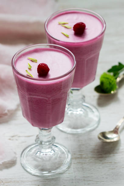 istock Berry-fruit mousse decorated with raspberries on a light background. 1203623915