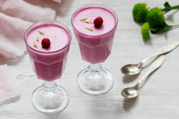 istock Berry-fruit mousse decorated with raspberries on a light background. 1203623916