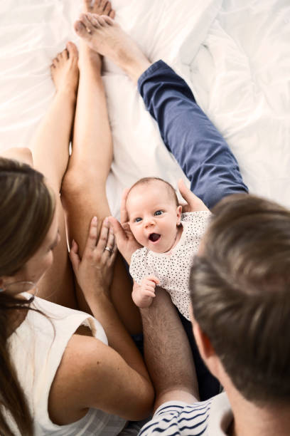 istock Mother ,father and baby in bed 1203624616